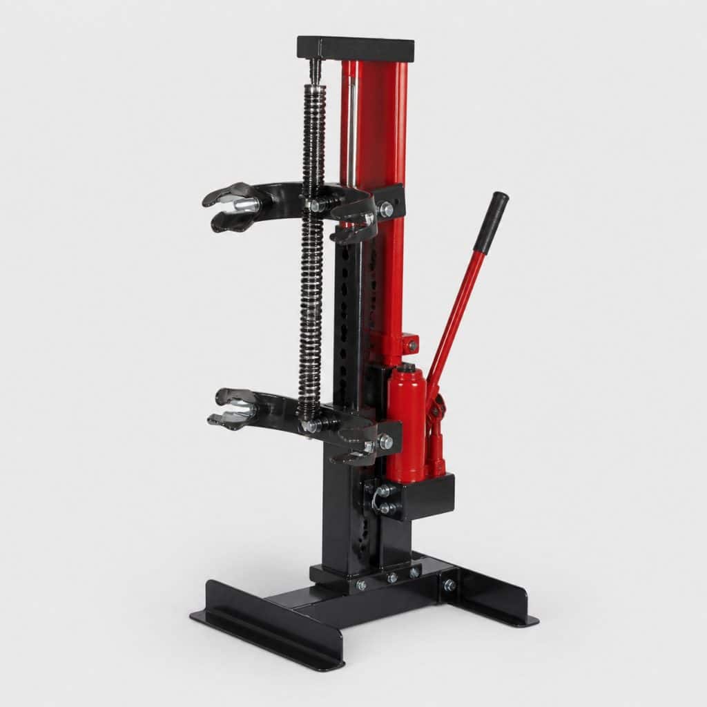 Compresseur de ressort hydraulique posé sur fond clair